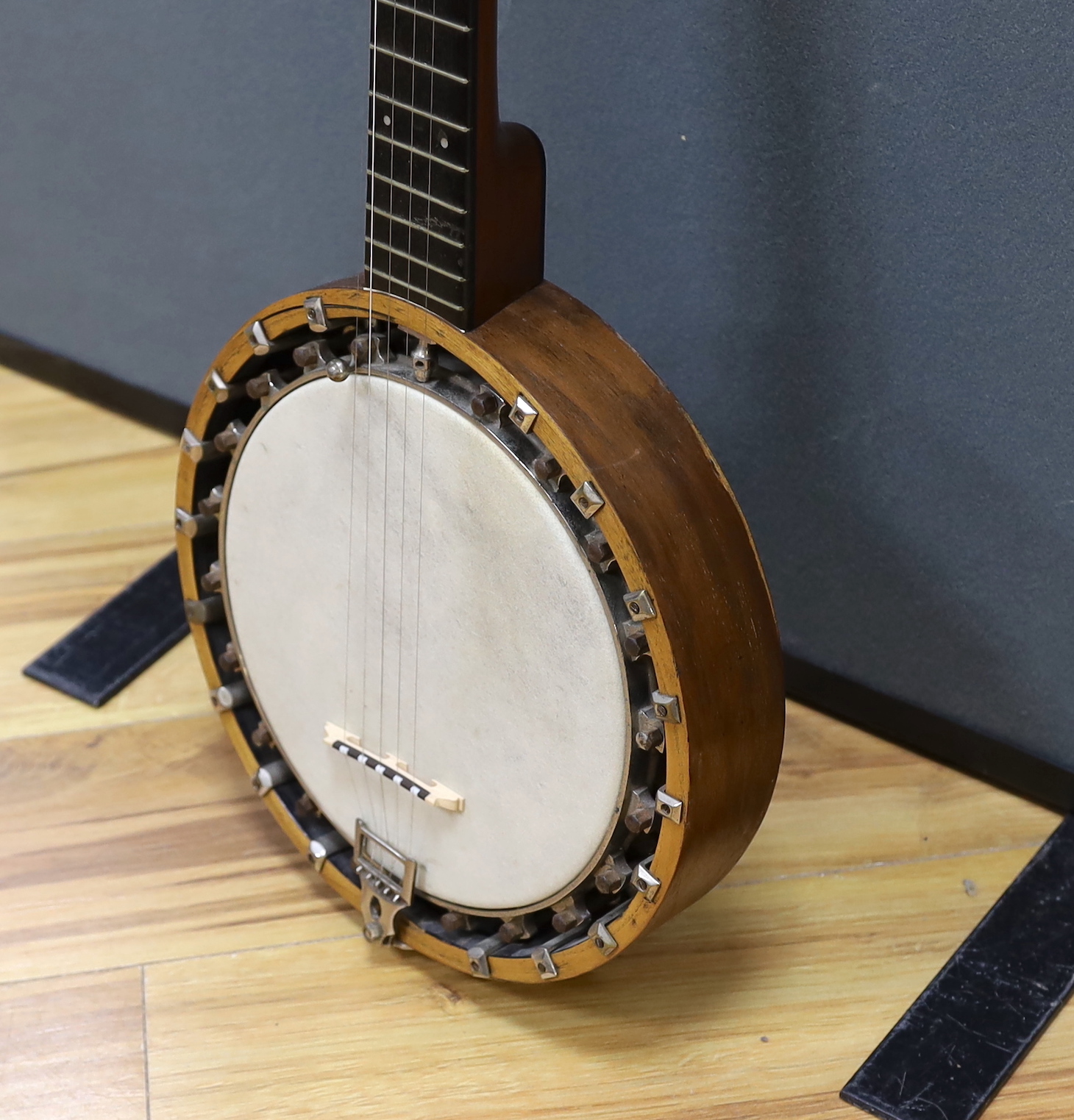 A six string banjo, unmarked, in a hard case by Ashbury